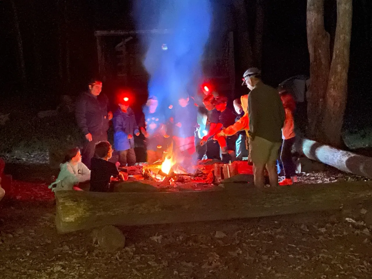 Pack 60 families gathered around a campfire during a fall campout at Camp Mountaineer