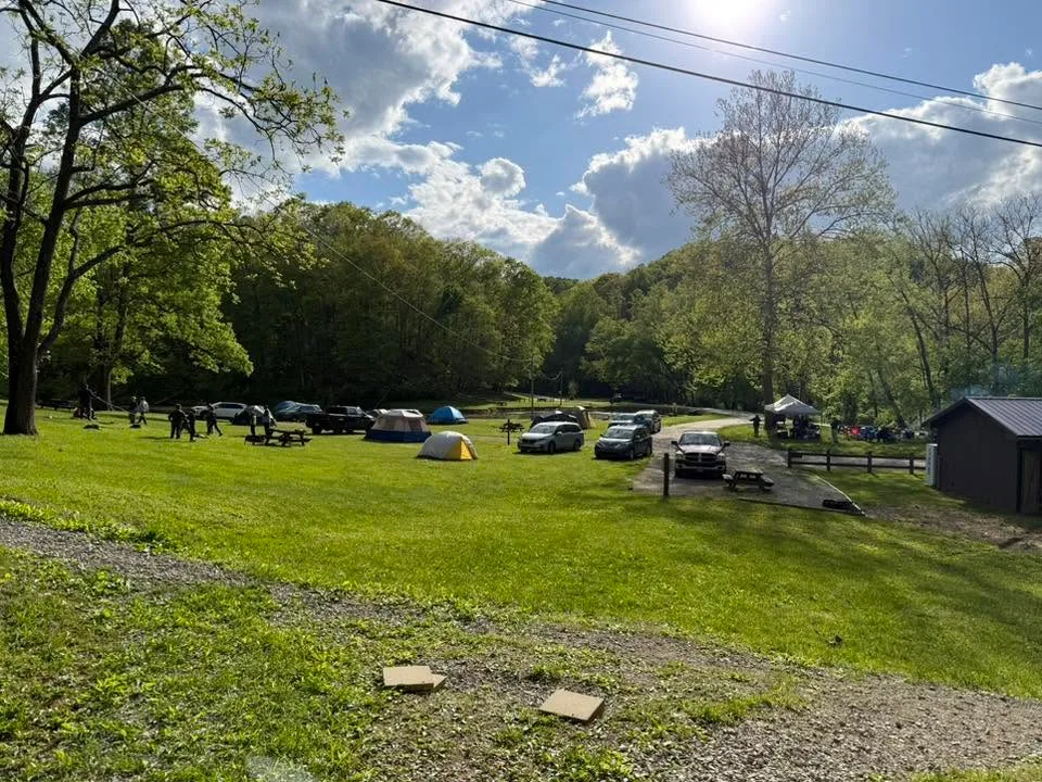 Pack 60 tents set up in a sunny campground at North Bend State Park