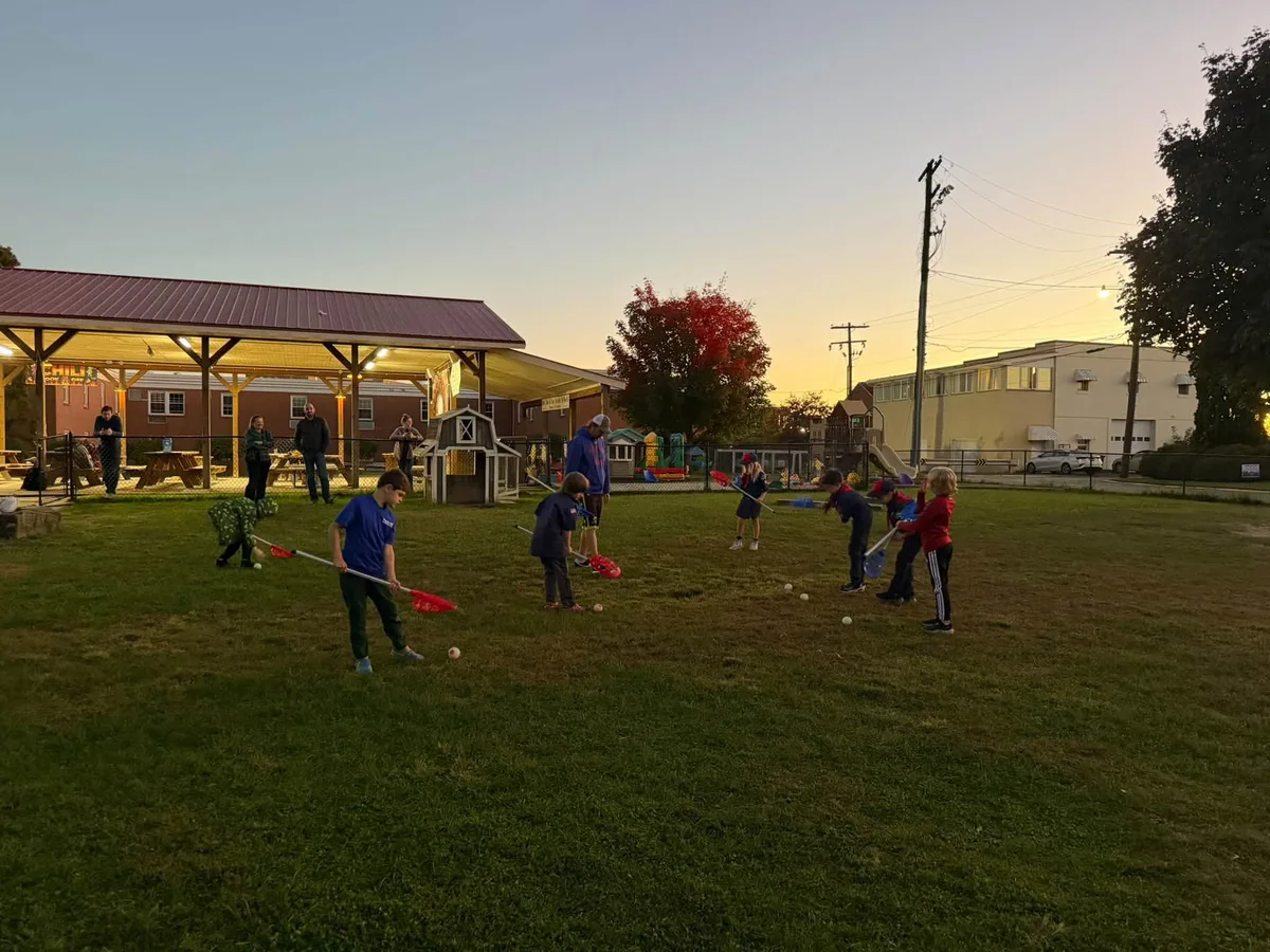 Scouts practicing with lacrosse sticks during a Wolf den demo